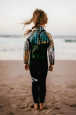 Girls wetsuit on beach